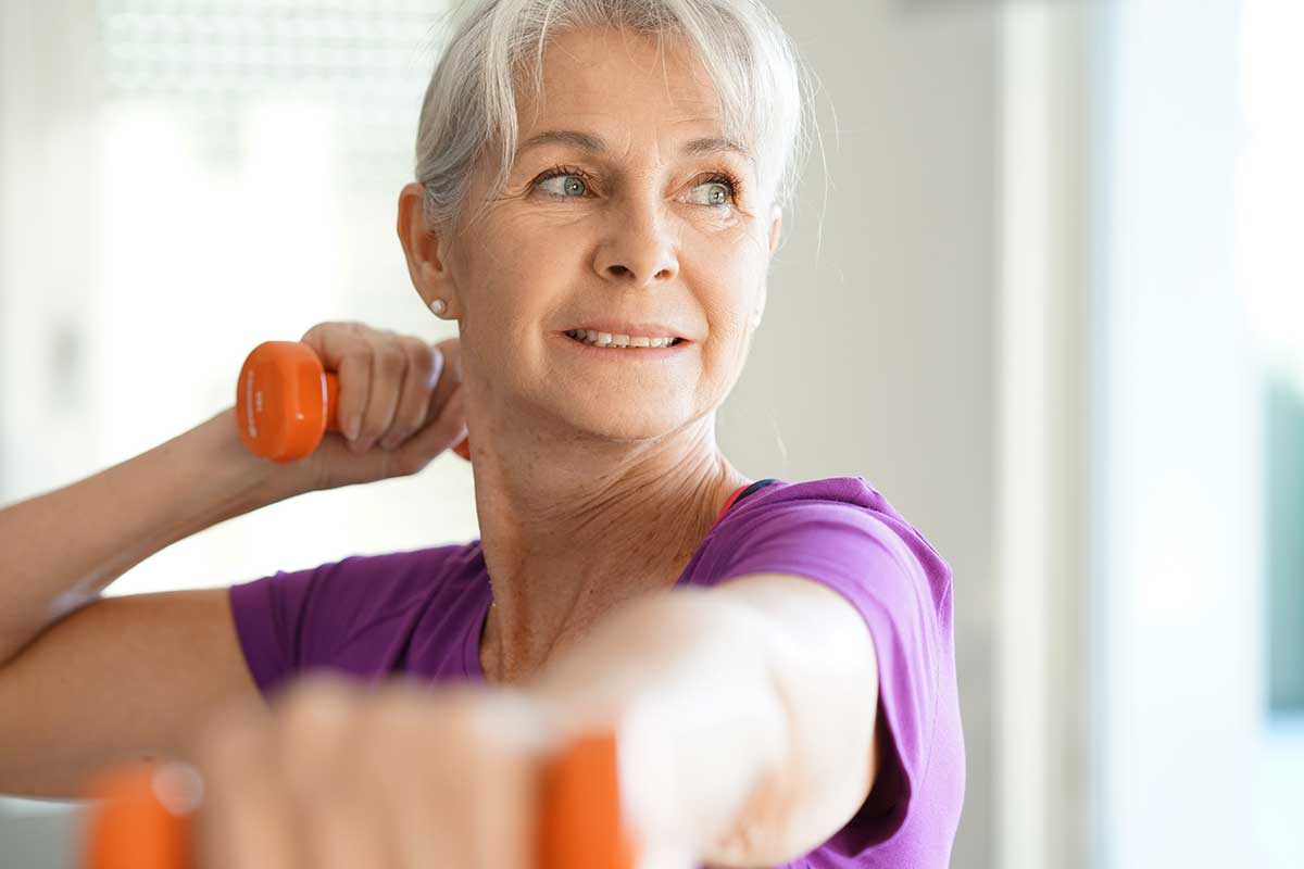 senior woman working out with small hand weights