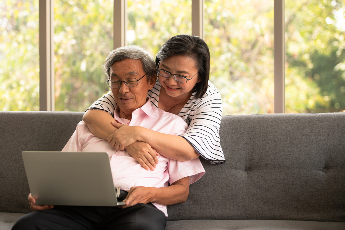 Asian married couple using a laptop