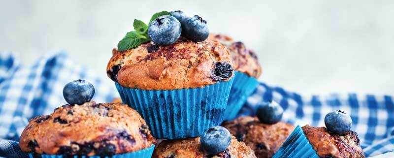 muffins stacked on top of each other with blue berries
